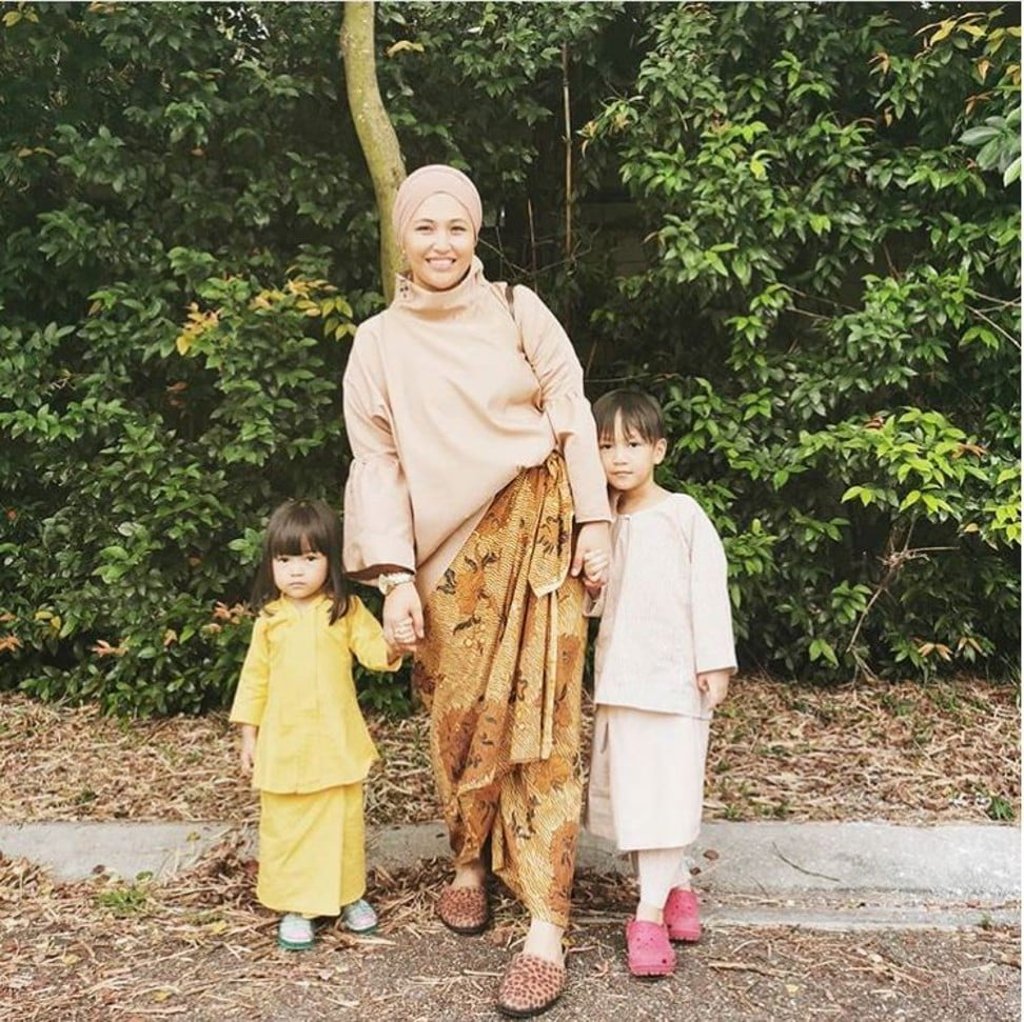 Fashion designer Helina Mohd Noor wearing a hijab in the turban style with two of her children.