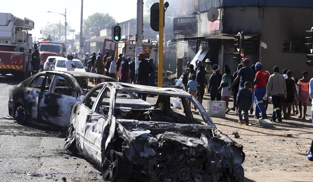 Burnt out cars on the outskirts of Johannesburg. Photo: AP Burnt out cars on the outskirts of Johannesburg. Photo: AP