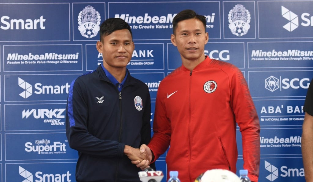 Cambodia captain Soeuy Visal with Hong Kong captain Yapp Hung-fai.