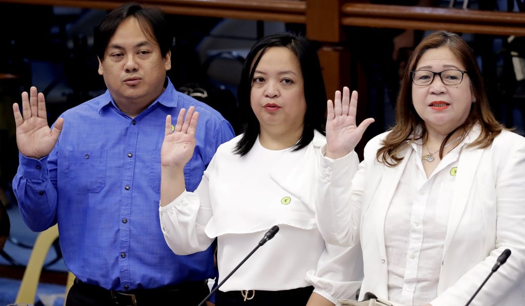 Antonio Sanchez’s family, from left, son Allan Antonio Sanchez, daughter Ave Marie Tonee Sanchez and wife Elvira Sanchez, take their oaths at the Senate hearing. Photo: AP Antonio Sanchez’s family, from left, son Allan Antonio Sanchez, daughter Ave Marie Tonee Sanchez and wife Elvira Sanchez, take their oaths at the Senate hearing. Photo: AP