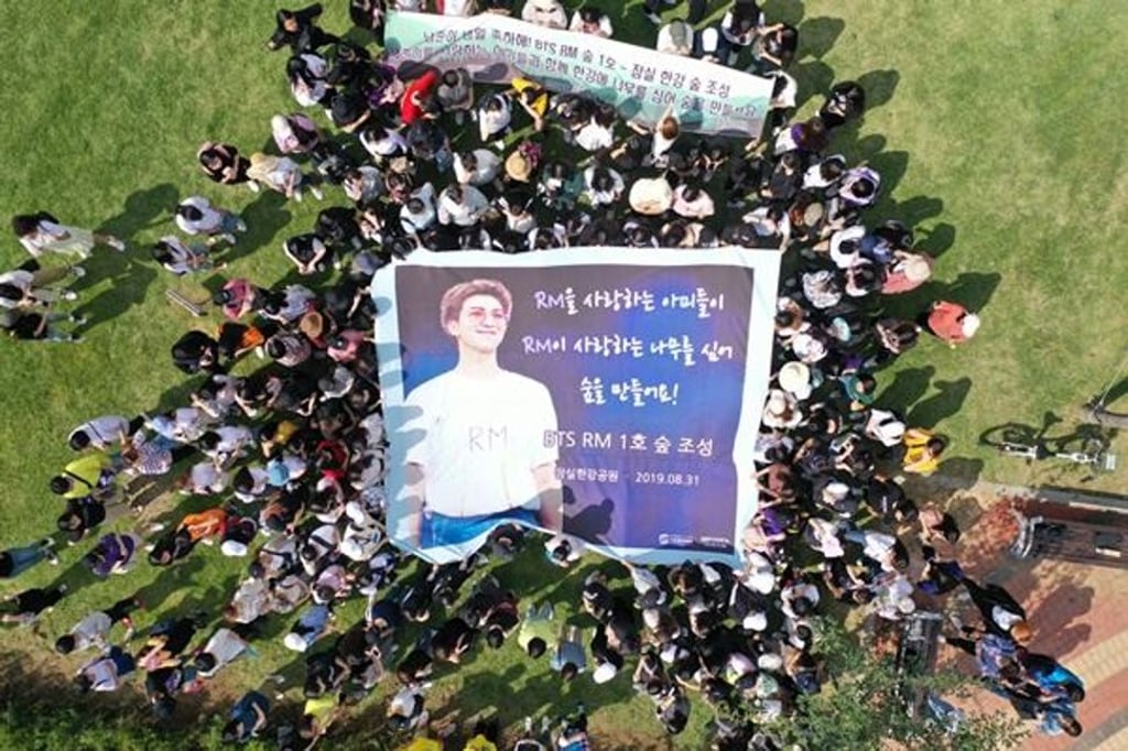 A group of fans of BTS boy band member RM celebrate Saturday’s opening of RM Forest in Seoul. Photo: Yonhap A group of fans of BTS boy band member RM celebrate Saturday’s opening of RM Forest in Seoul. Photo: Yonhap