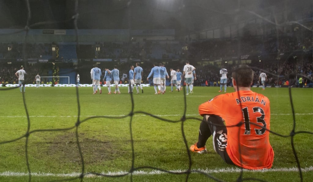 West Ham's goalkeeper Adrian sits on his line after a goal by Manchester City's Edin Dzeko during the 2014 English League Cup semi-final. Photo: AP