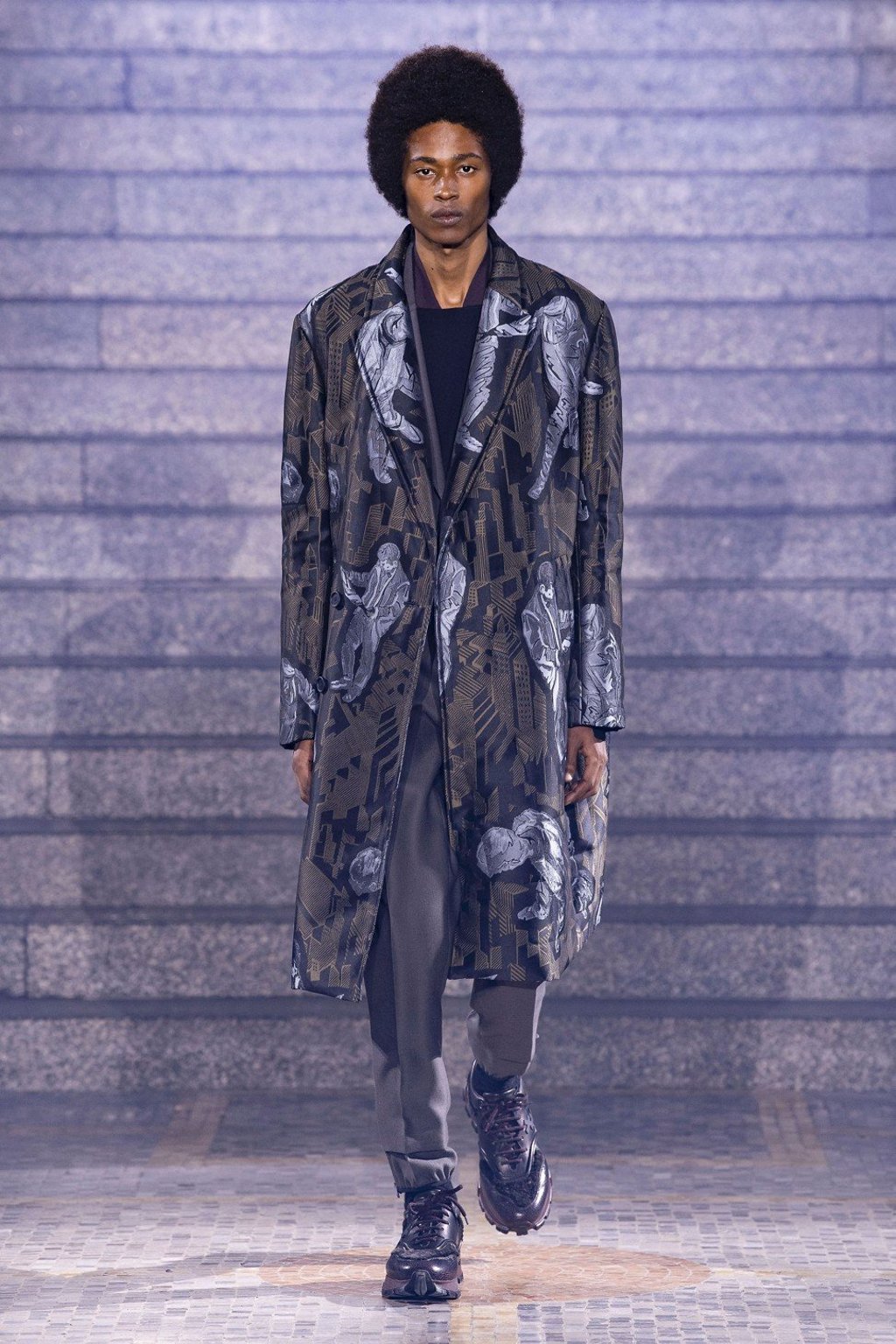A model presents creations, including an overcoat featuring printed urban abstractions, from Ermenegildo Zegna’s fall/winter 2019 collection show in Milan.