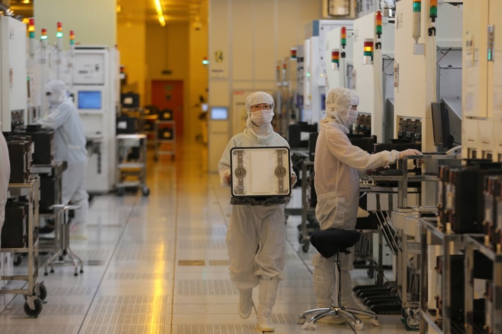 Chinese employees dressed in dustproof clothing work at the plant of SMIC (Semiconductor Manufacturing International Corporation) in Beijing in 2012. Photo: Handout