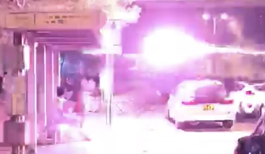 A screen capture of an online video showing the moment fireworks are thrown from a car.