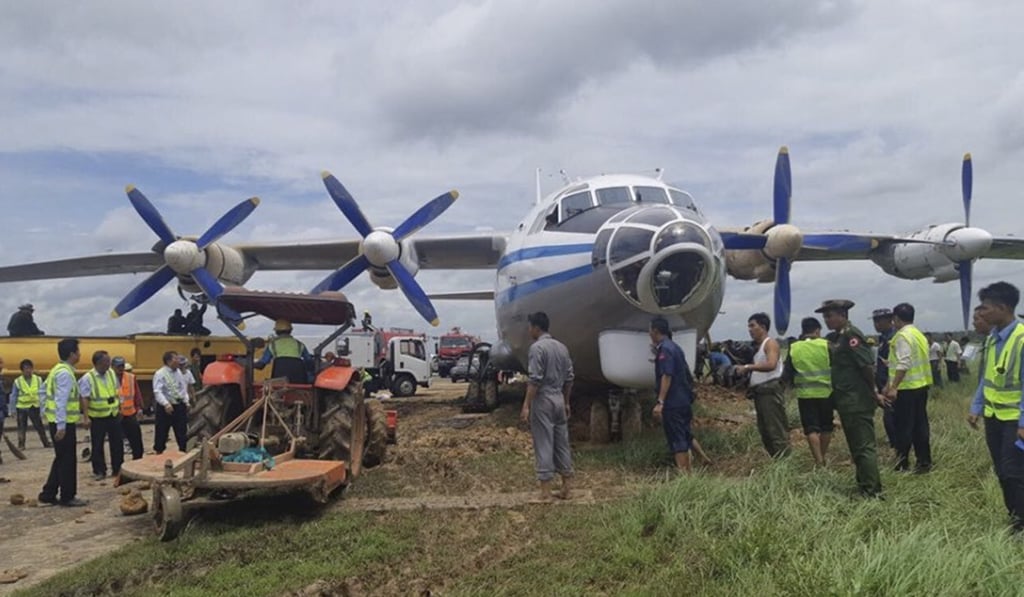 Workers carrying out a removal operation on a damaged Myanmar military transport aircraft after it skidded off the runway at Yangon International Airport on Thursday. Photo: Myanmar Department of Civil Aviation via EPA-EFE
