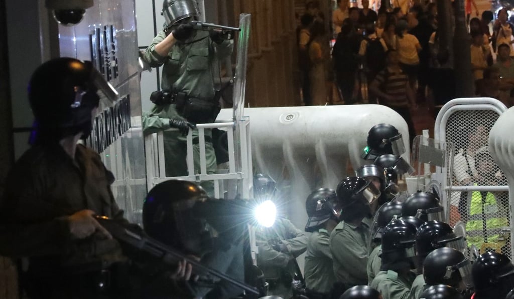 Riot police monitor the movement of protesters in front of Mong Kok Police Station on Friday. Photo: Edmond So