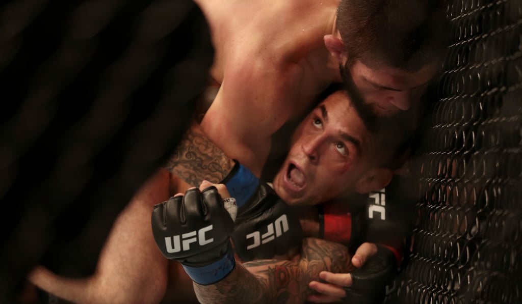 Khabib Nurmagomedov tries to choke Dustin Poirier. Photo: Reuters Khabib Nurmagomedov tries to choke Dustin Poirier. Photo: Reuters