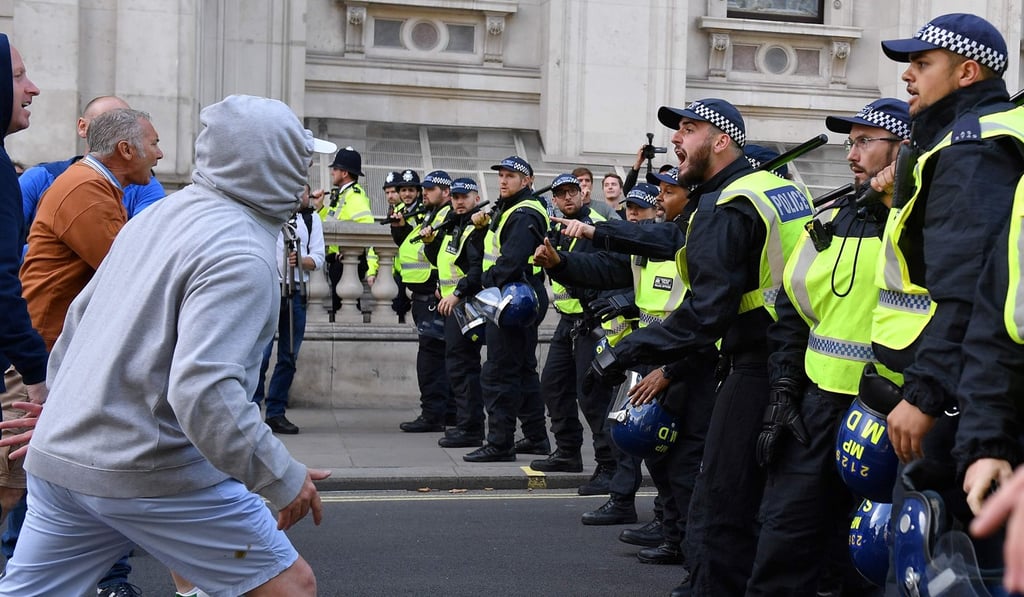 Demonstrators and police officers face off during an anti-government protest calling for Boris Johnson’s resignation, near Downing Street in central London on Saturday. Photo: AFP