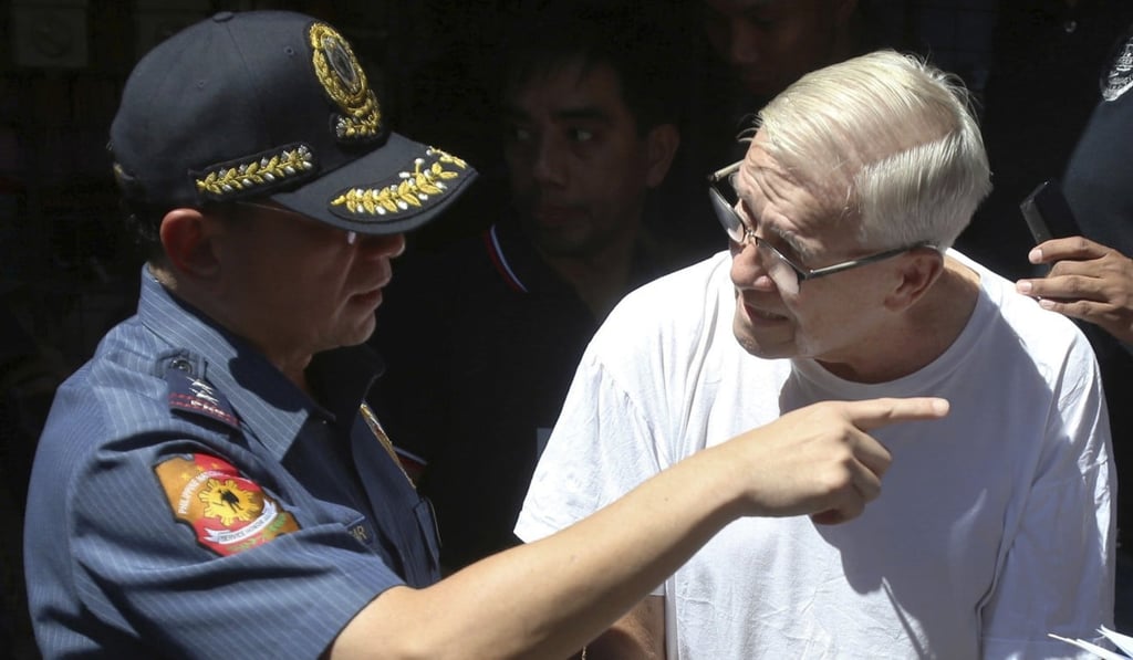 Philippine police with Father Pius Hendricks. Photo: AP