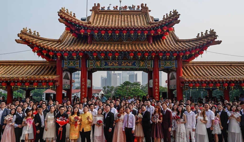 A group photograph of the assembled couples ended the event. Photo: AFP