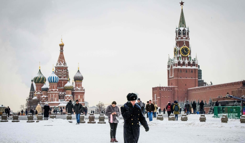 A serviceman walks in front of St. Basil's Cathedral and the Kremlin on Red Square in Moscow. Photo: AFP