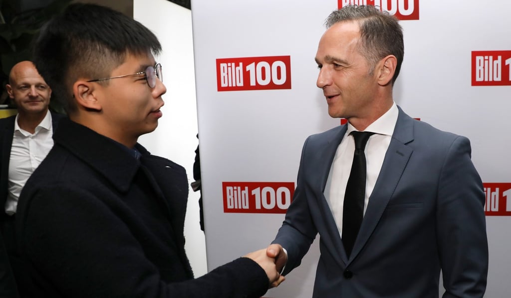 Hong Kong activist Joshua Wong (left) shakes hands with German Foreign Minister Heiko Maas in Berlin on Monday. Photo: EPA-EFE