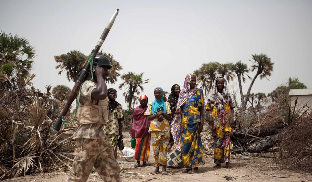 A Nigerian soldier, with a rocket-propelled grenade, patrols on the outskirt of the town previously hit by insurgent attacks. Photo: AFP