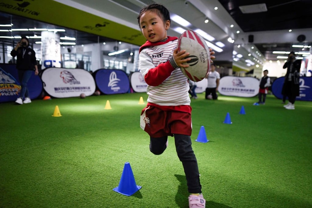 A young girl takes part in a training session at a youth rugby club in southwest China. Photo: AFP A young girl takes part in a training session at a youth rugby club in southwest China. Photo: AFP