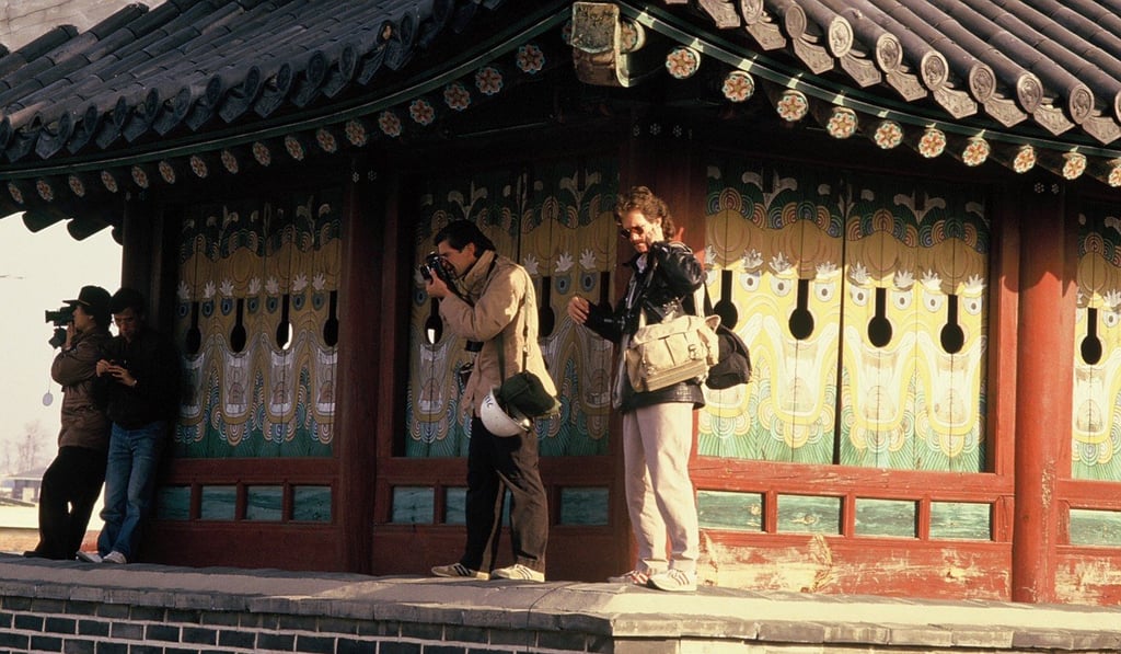 Charlie Cole, right and James Nachtwey, left, working during South Korea’s first free election campaign in 1987. Photo: Kim Newton
