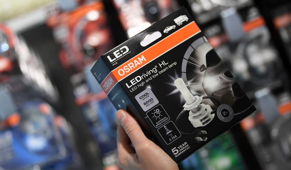 An employee of German manufacturer Osram holds a boxed light bulb at the company headquarters in Munich in August. Photo: Reuters