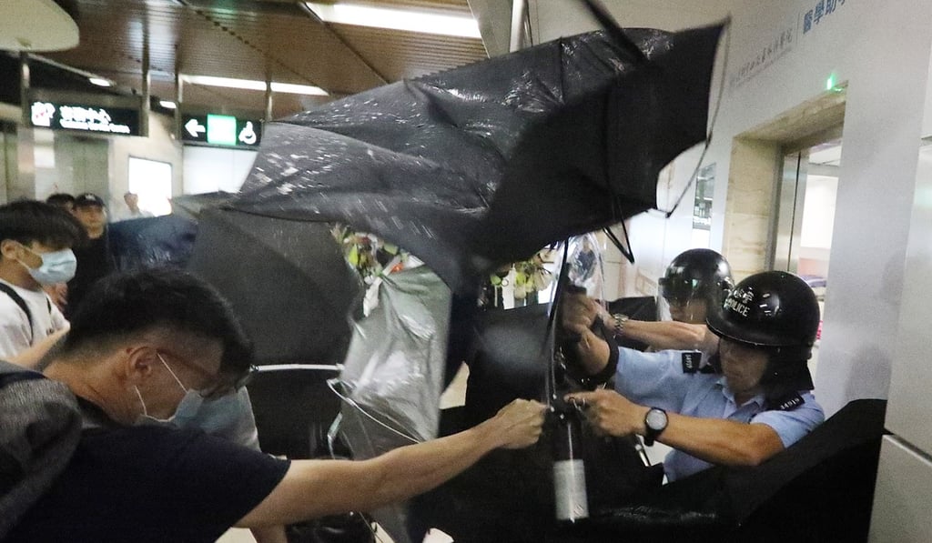 Police officers aim pepper spray at protesters during a brawl at the Sha Tin MTR station on September 7. Photo: Felix Wong