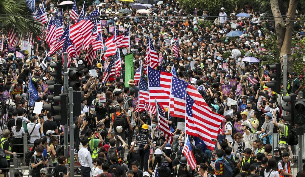 Extradition bill protesters with US flags as they marched to the Consulate General of the United States this month to support the Hong Kong Human Rights and Democracy Act. Photo: SCMP