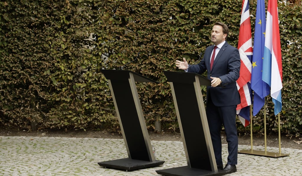 Luxembourg's Prime Minister Xavier Bettel addresses a press conference next to an empty lectern intended for Boris Johnson. Photo: AP