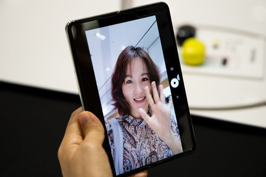 A customer takes a selfie with Samsung’s Galaxy Fold smartphone. Photo: Bloomberg