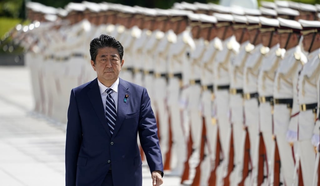 Japanese Prime Minister Shinzo Abe reviews an honour guard before attending the gathering of senior officers at the Defence Ministry in Tokyo. Photo: EPA