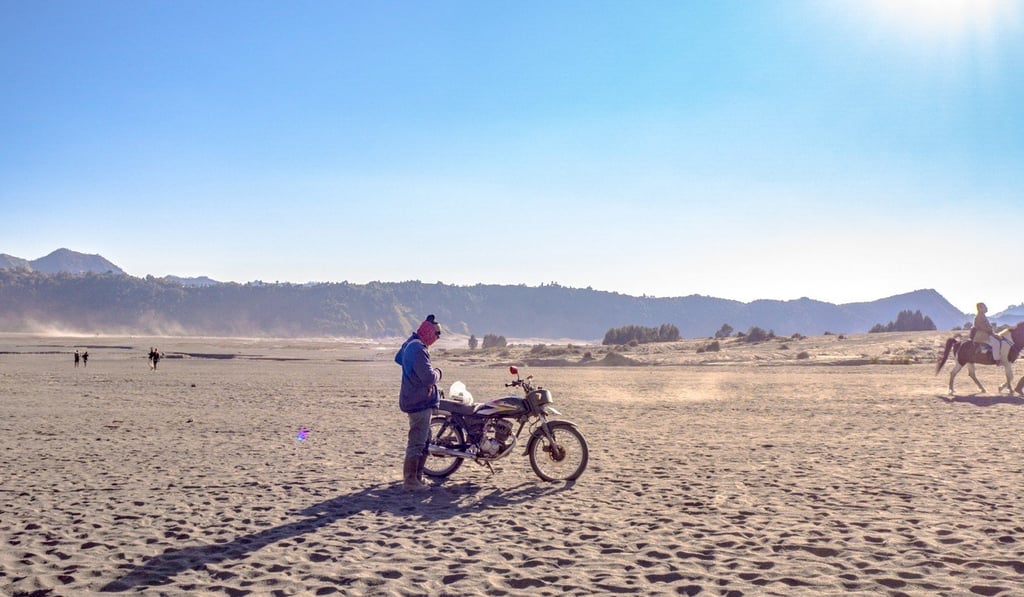 A lone biker on the sea of sand between Mount Bromo car park and the volcano. Photo: Nam Cheah