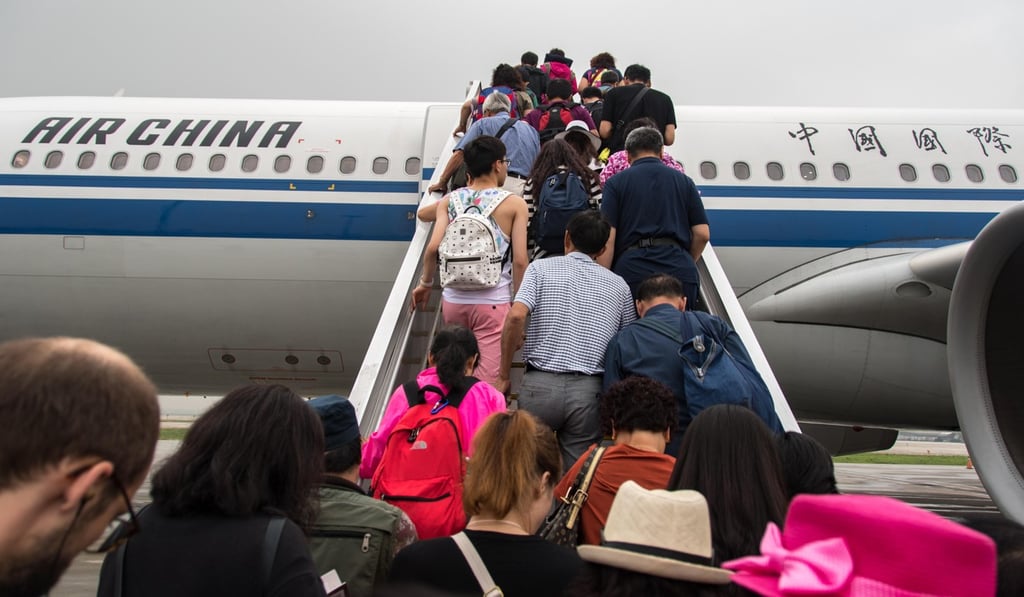 Passengers board an Air China plane in Beijing. Photo: Alamy Stock Photo