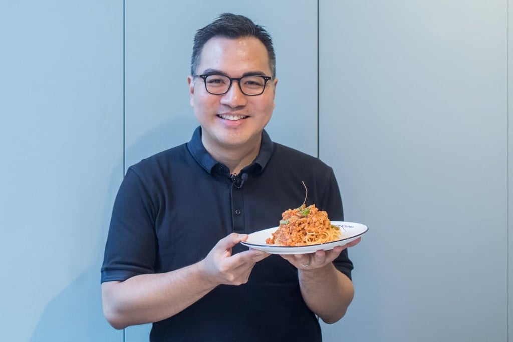 David Yeung, co-founder and chief executive of social venture Green Monday, poses with a dish of spaghetti bolognese made with plant-based meat substitute Omnipork at the Kind Kitchen restaurant in Hong Kong on June 20. Photo: Bloomberg