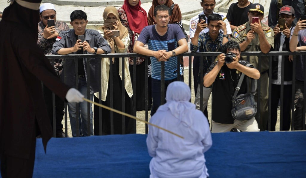 The public flogging was watched by dozens. Photo: Agence France-Presse