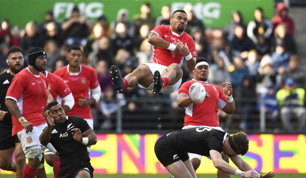 Almost half of Tonga’s players (in red) were actually born in New Zealand and would be eligible to play for the All Blacks. Photo: AP