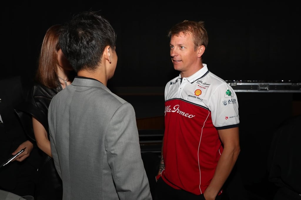 Taiwanese singer Jimmy Lin and wife Kelly Chen meet Kimi Räikkönen behind the scenes in Singapore. Photo: Getty