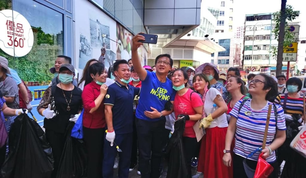 Lawmaker Junius Ho poses with supporters he mobilised for the clean-up operation, in which some participants targeted so-called Lennon Walls on Saturday morning. Photo: Handout