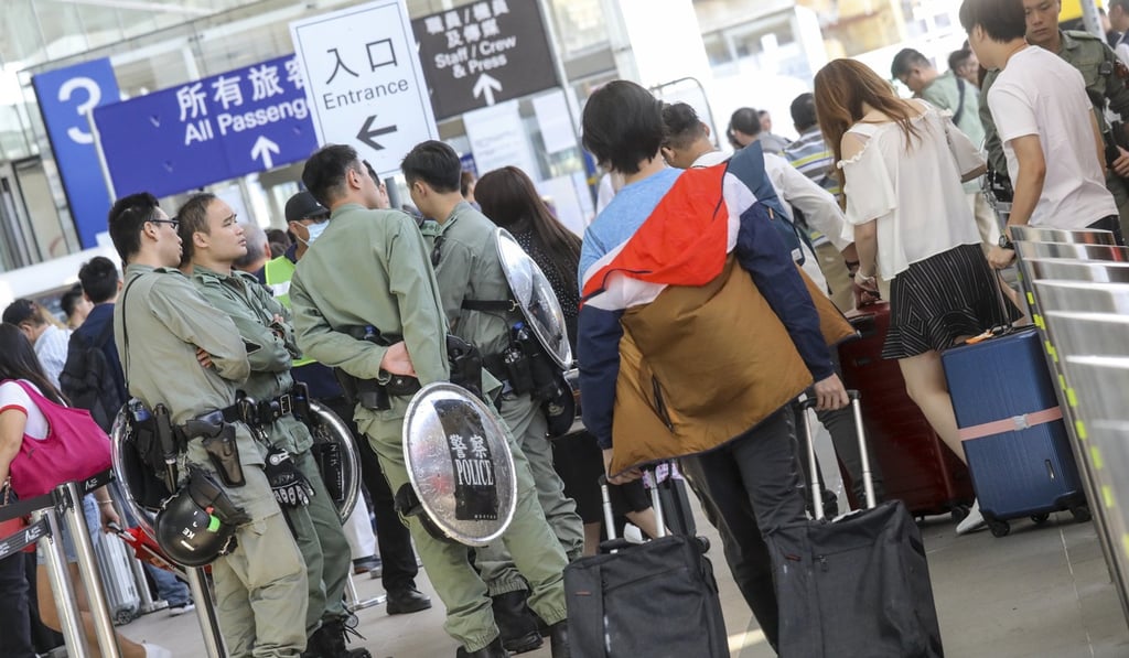Riot police stationed at Hong Kong airport on Sunday amid the threat of organised disruption. Photo: K. Y. Cheng Riot police stationed at Hong Kong airport on Sunday amid the threat of organised disruption. Photo: K. Y. Cheng