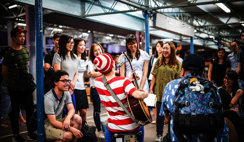 A musician entertains a crowd at Hong Kong’s Star Ferry. Photo: Shutterstock A musician entertains a crowd at Hong Kong’s Star Ferry. Photo: Shutterstock
