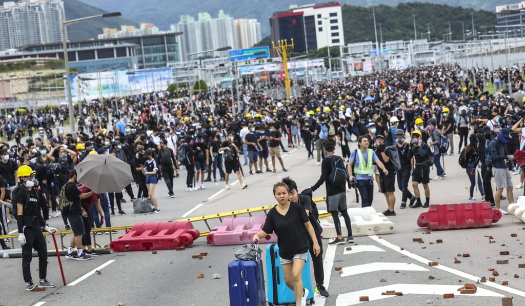 Travellers and airline crew on September 1 were forced to make their way to the airport on foot after protesters crippled transport links. Photo: Dickson Lee
