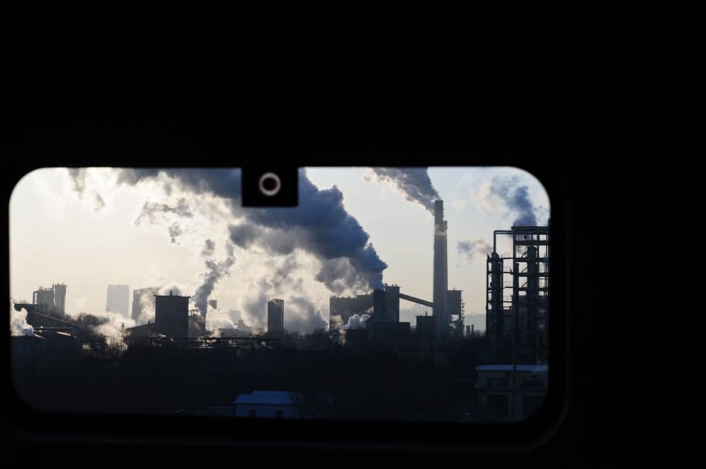 A high-speed train travels past a coal plant outside Changchun, in Jilin province, China. Photo: Alamy
