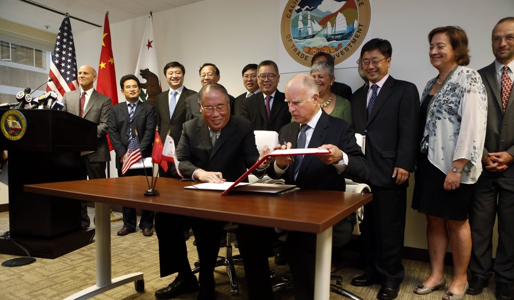 California’s then governor Jerry Brown (front right) and China’s top climate official Xie Zhenhua (front left) sign an agreement on climate change cooperation in 2014. Photo: AP California’s then governor Jerry Brown (front right) and China’s top climate official Xie Zhenhua (front left) sign an agreement on climate change cooperation in 2014. Photo: AP