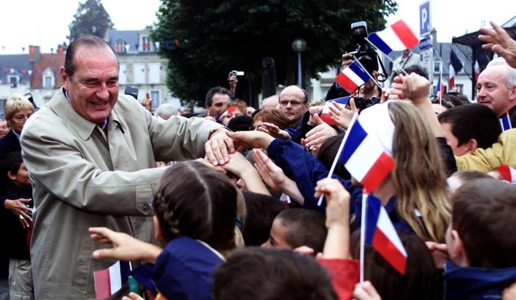 Former French President Jacques Chirac shakes hands with residents of Saint-Amand Montrond in October 2000. Photo: Reuters
