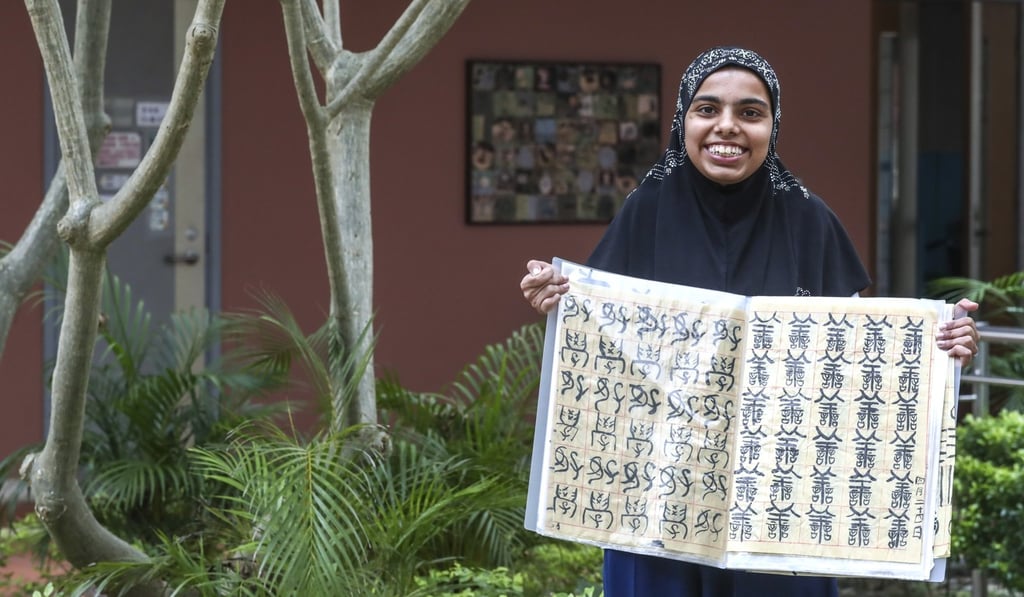Ali Faria Hussain with some of her calligraphy, one of her main passions in life. Photo: Jonathan Wong