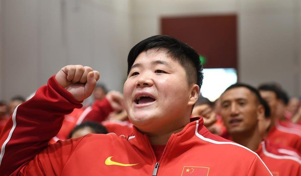 Gong Lijiao takes the athletes’ oath at the sending off ceremony of the Chinese squad to the Doha World Championships. Photo: Xinhua Gong Lijiao takes the athletes’ oath at the sending off ceremony of the Chinese squad to the Doha World Championships. Photo: Xinhua