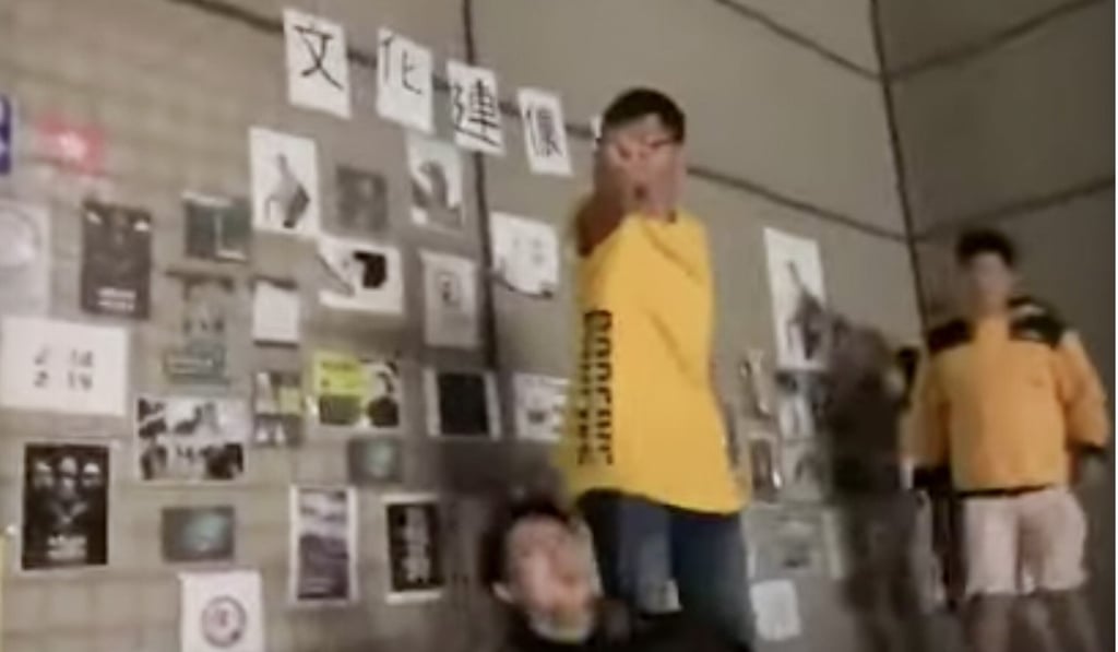 A screen grab from a video showing students clashing over a Lennon Wall at Chinese Culture University in Taipei on Wednesday. Photo: YouTube