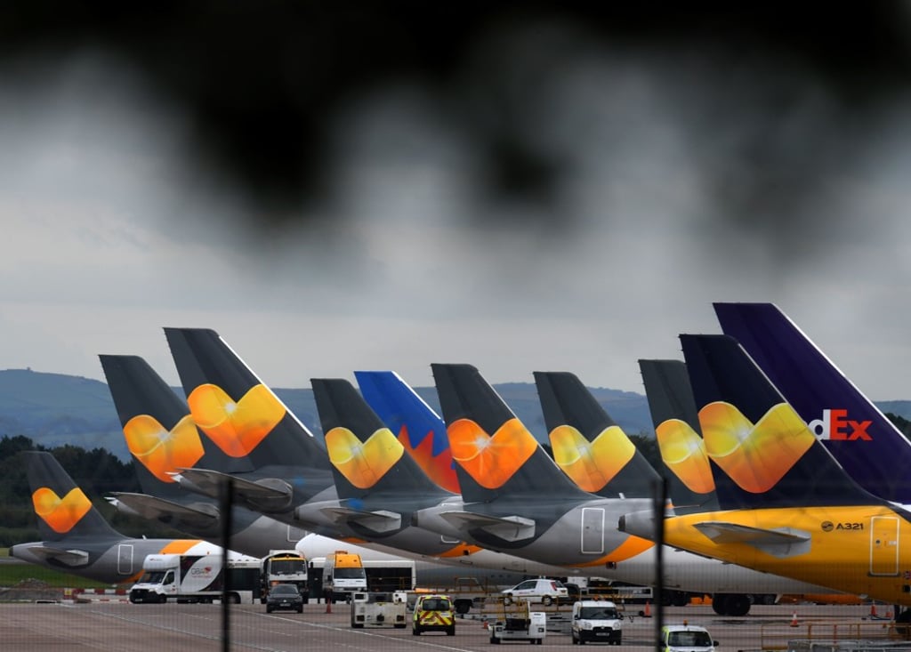 Thomas Cook logos are pictured on the tail fins of the company's passenger aircraft at Manchester Airport in northern England on September 23. Photo: AFP