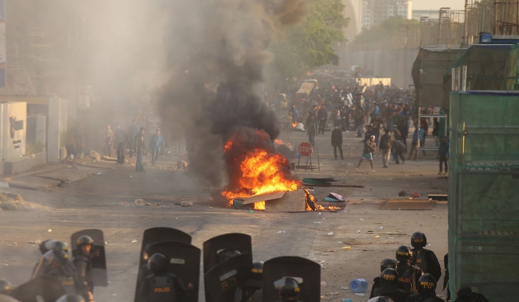 Riot police face off with protesters in Sulawesi on Tuesday. Photo: AFP