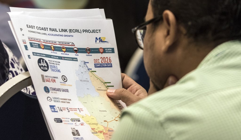 A journalist looks at documents about the East Coast Rail Link project in April. Photo: EPA