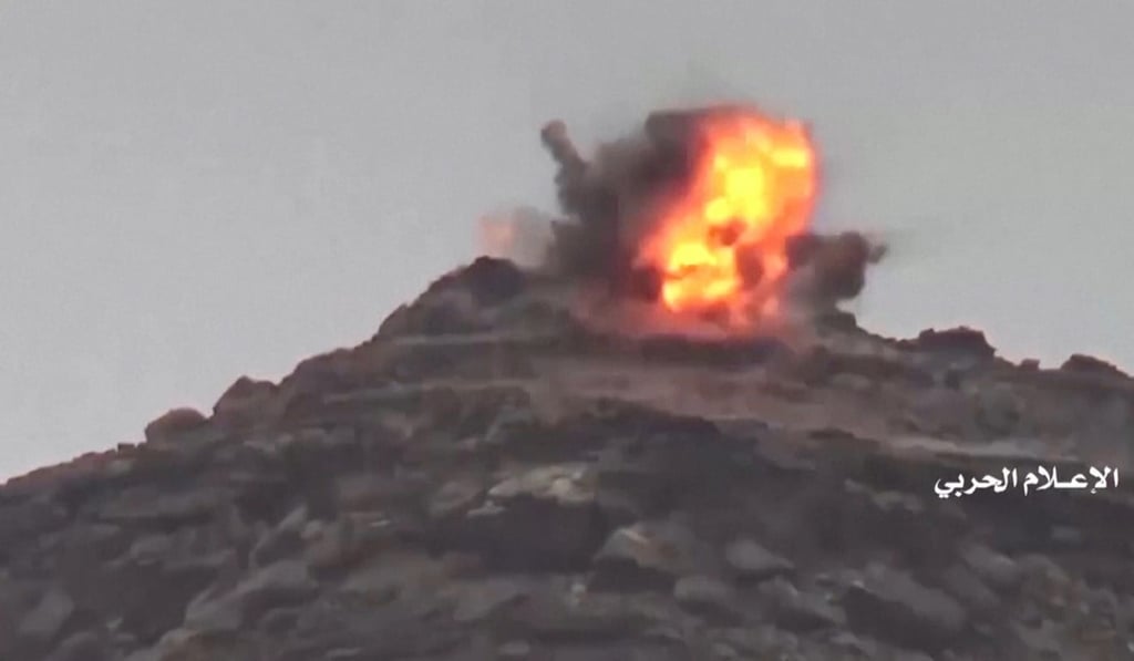 An explosion is seen during an alleged attack of Houthi forces at Saudi positions near the border with Saudi Arabia's southern region of Najran. Photo: Handout via Reuters