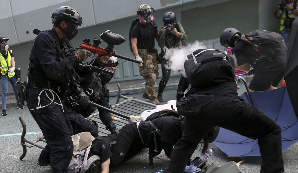 Police officers arrest anti-government protesters in Hong Kong on Sunday. Photo: EPA