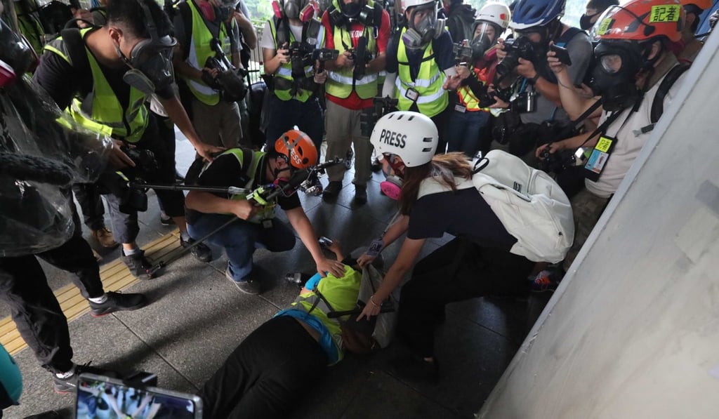 First-aiders attend to Indonesian journalist Veby Indah in Wan Chai on Sunday. Photo: Felix Wong