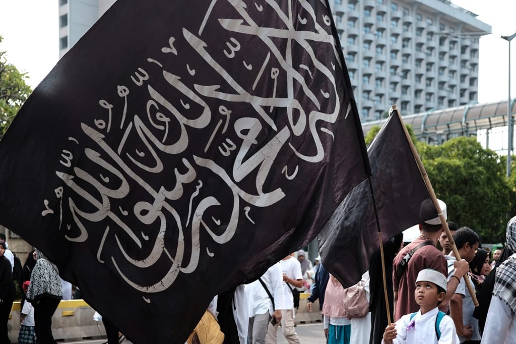 A boy waves a flag as thousands of Indonesian Islamists attend a rally in Jakarta on December 2, 2018, to commemorate the second anniversary of a demonstration which led to the fall of Jakarta's then Christian governor Basuki “Ahok” Purnama. Photo: AFP A boy waves a flag as thousands of Indonesian Islamists attend a rally in Jakarta on December 2, 2018, to commemorate the second anniversary of a demonstration which led to the fall of Jakarta's then Christian governor Basuki “Ahok” Purnama. Photo: AFP