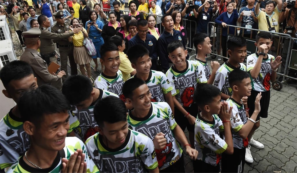 The rescued boys and their coach arrive for a press conference in Chiang Rai following their discharge from hospital. Photo: AFP/Lillian Suwanrumpha